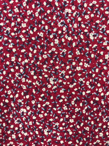 Tiny off white flowers on red background (sold in 25cm units)