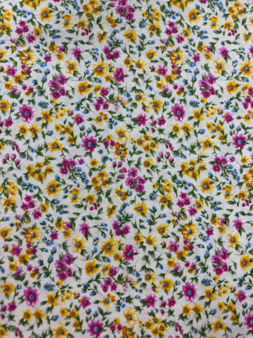 Tiny pink and yellow flowers on white background (sold in 25cm units)