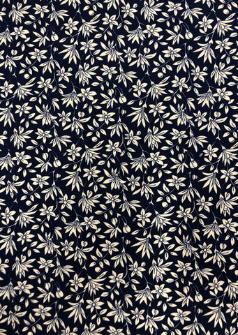 Cream leaves on navy background