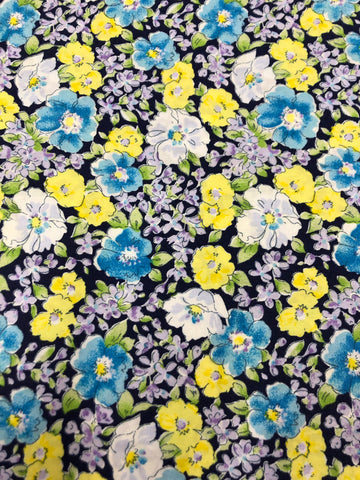 Blue, white and yellow flowers on navy background (sold in 25cm units)